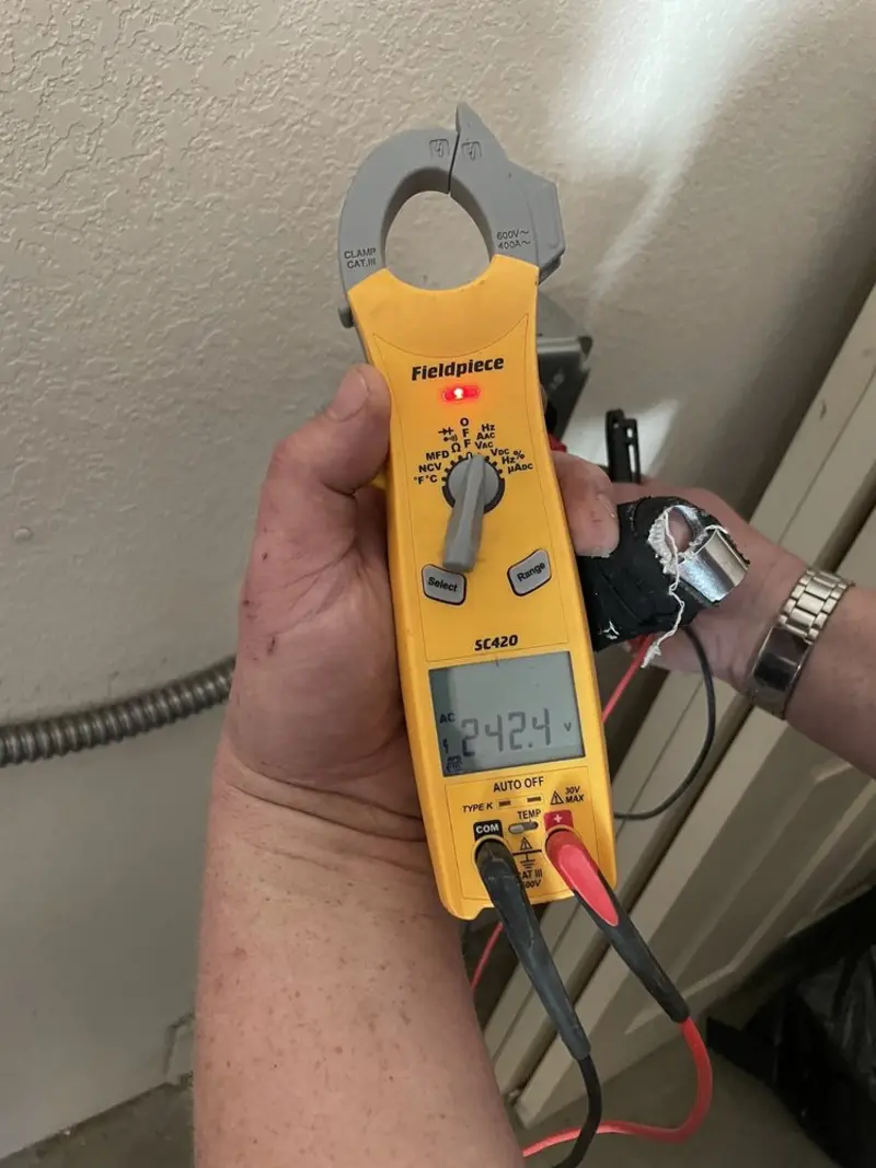 Voltage testing with clamp meter during Outlet Installation in Dillon